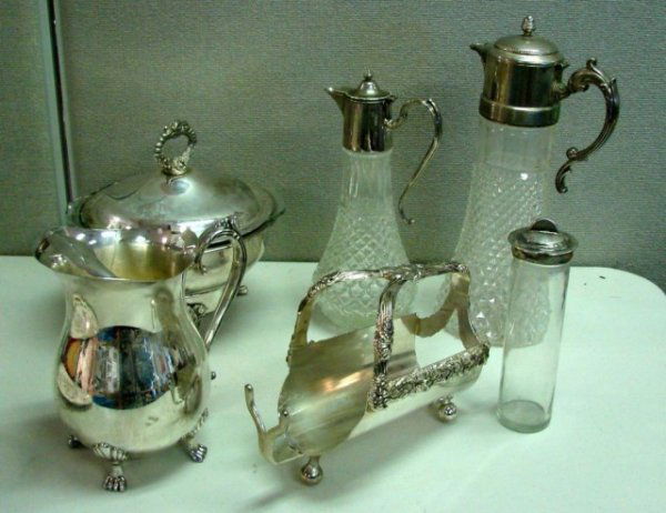 Lot of Silver Plate incl. 2 pitchers w/silver tops: Box lot of silver plate including a pitcher, two glass pitchers with silver tops, a wine bottle holder, chafing dish with Pyrex insert, and a silver topped jar.