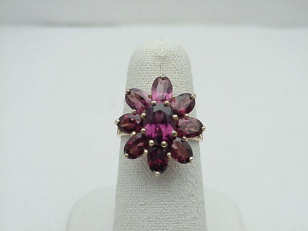Lady's pink tourmaline floral ring: Lady's pink tourmaline ring consisting of 9 oval shaped pink tourmaline 2.55ctw in a floral design with filigree 10kyg mounting and finger size 5.34.