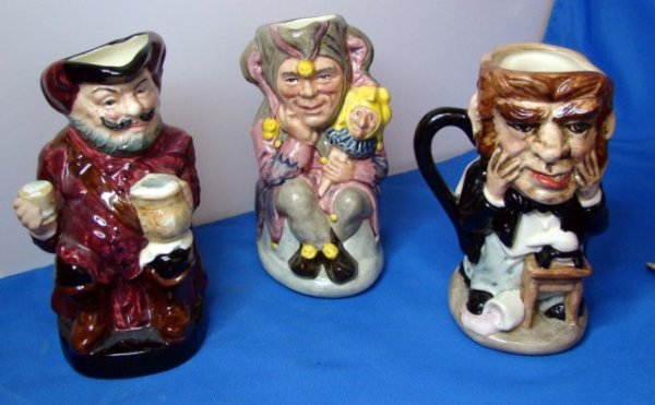 3 Doulton Toby Jugs Dr. Jekyll, Falstaff, Jester: 3 Royal Doulton Toby Jugs - Dr. Jekyll and Mr. Hyde, Falstaff, and the Jester, approx. 5 1/2" tall, marked as shown in photo, no chips or cracks.