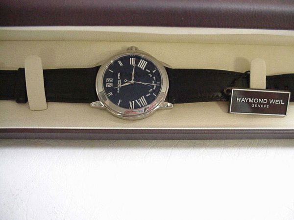 Man's Raymond Weil Tradition watch: Man's Raymond Weil Tradition watch with black roman dial, Swiss movement, sapphire crystal and water resistant to 30m. Comes with leather band, original box and papers.