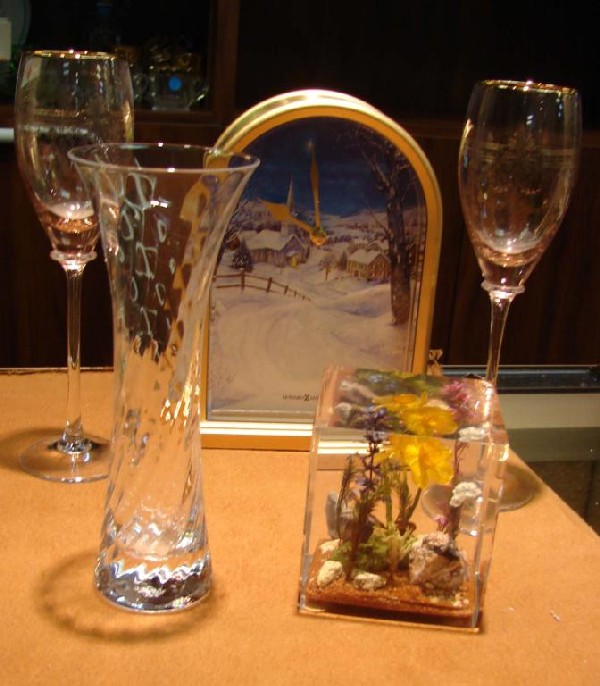 2 pink Champagne flutes, Howard Miller clock: Howard Miller clock, 2 pink champagne flutes, Lucite paper weight and a crystal bud vase.