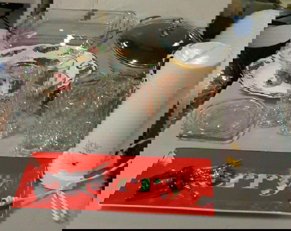 Box Lot: Chantal pan, Pyrex, dishes, glasses, etc.: Box lot: oval Chantal sauté pan, 2 Pyrex dishes, Ice tea maker, 8 heavy iced tea glasses, candle holders, copper mold, etc. Sold AS IS.