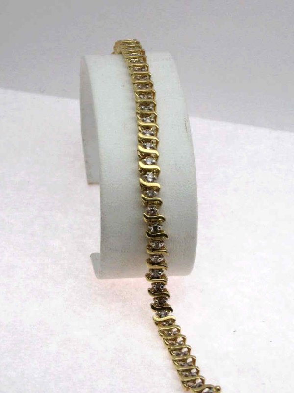 Lady's 14kyg 2ctw diamond bracelet: Lady's 14kyg diamond bracelet 8.5 grams with round full cut diamonds 2ctw prong set in a "S" bar design.