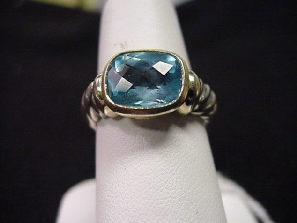 Sterling/14kyg David Yurman Ring blue topaz: Lady's sterling and 14kyg blue topaz ring 8.6 grams with one checkerboard blue topaz measuring 10x8mm bezel set in 14kyg with finger size 7.