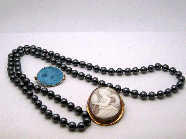 Lot of cameos and hematite beads: Lady's lot of 2 cameos oval shaped with gold plated frame, 31X26" blue colored and 32"strand of hematite beads, 8mm individually knotted.