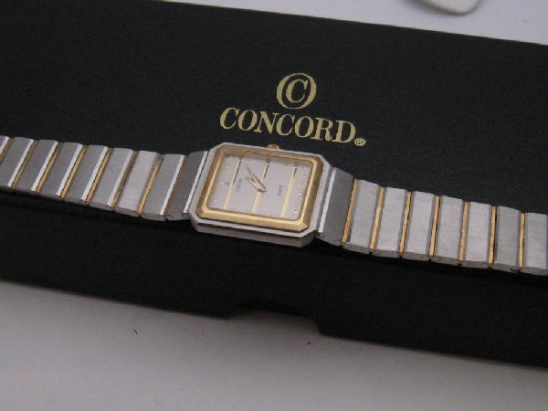 Man's Concord Mariner SG watch: Man's Concord Mariner SG watch with Swiss movement, gold striped dial, gold between the links and bezel. Comes with original box and papers.