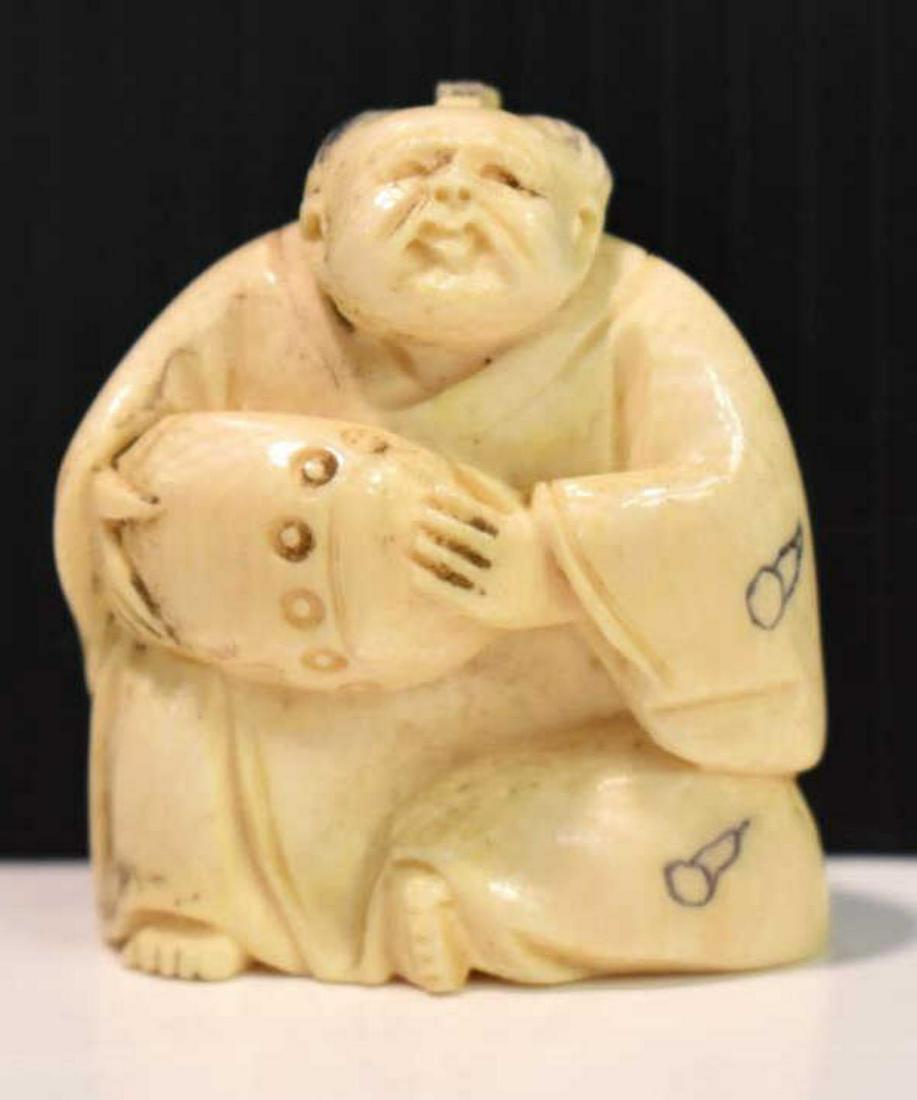 Netsuke Japanese Figurine: Netsuke Japanese Figurine. Hand carved with precision. Made in Japan. Signed on the bottom of the figurine.