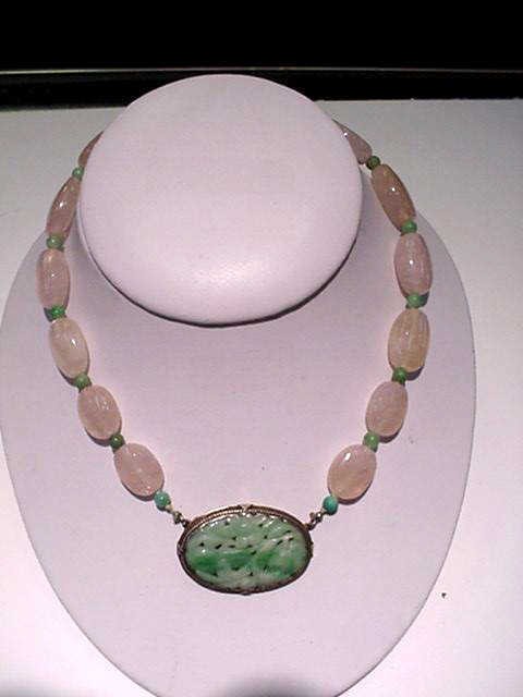 Vintage pink and green jade choker necklace: Vintage 17" pink and green jade necklace pink ovals graduating from 16mm to 24mm separated by 4mm green beads with ornate carved jade clasp framed in silver.