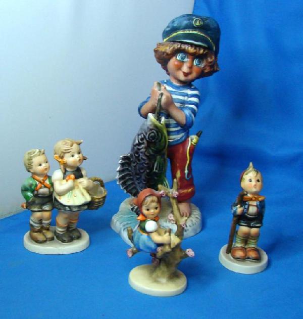 Large Goebel Boy w/Fish & 3 Hummels: Goebel Boy with a Large Fish signed Michel T, and 3 Hummels: Little Hiker 4", Apple Tree Girl 4", and To Market 4.25", no chips or cracks.