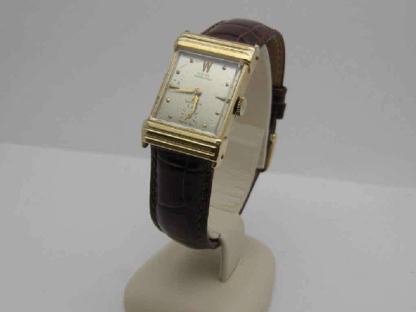 Vintage 14kyg Girard Perregaux watch: Man's vintage 14kyg Girard Perregaux watch, 1951with silver dial and second hand inset, mechanical movement, brown leather band and in good running condition. Does have engraving.