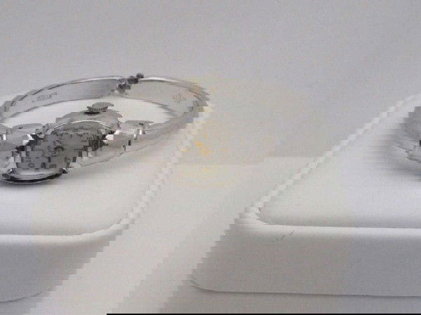 Goldtone Omega and lady's Bulova watch: Man's goldtone Omega wind up dress watch ( no crystal) and lady's Bulova cuff watch from 1954. Both in good working condition.