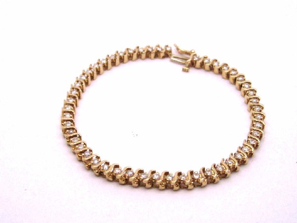 14kyg diamond bracelet 2ctw: Lady's 14kyg diamond bracelet 11.4 grams with round full cut diamonds prong set 2ctw with SI1-I1 clarity and H-J color. 7 inches in length.
