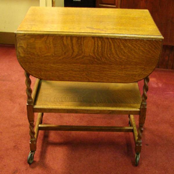 Antique Oak Drop Leaf Tea Cart on Wheels: Antique Oak Drop Leaf Tea Cart on Wheels, someone tried to cover up a scratch on top; can be refinished.