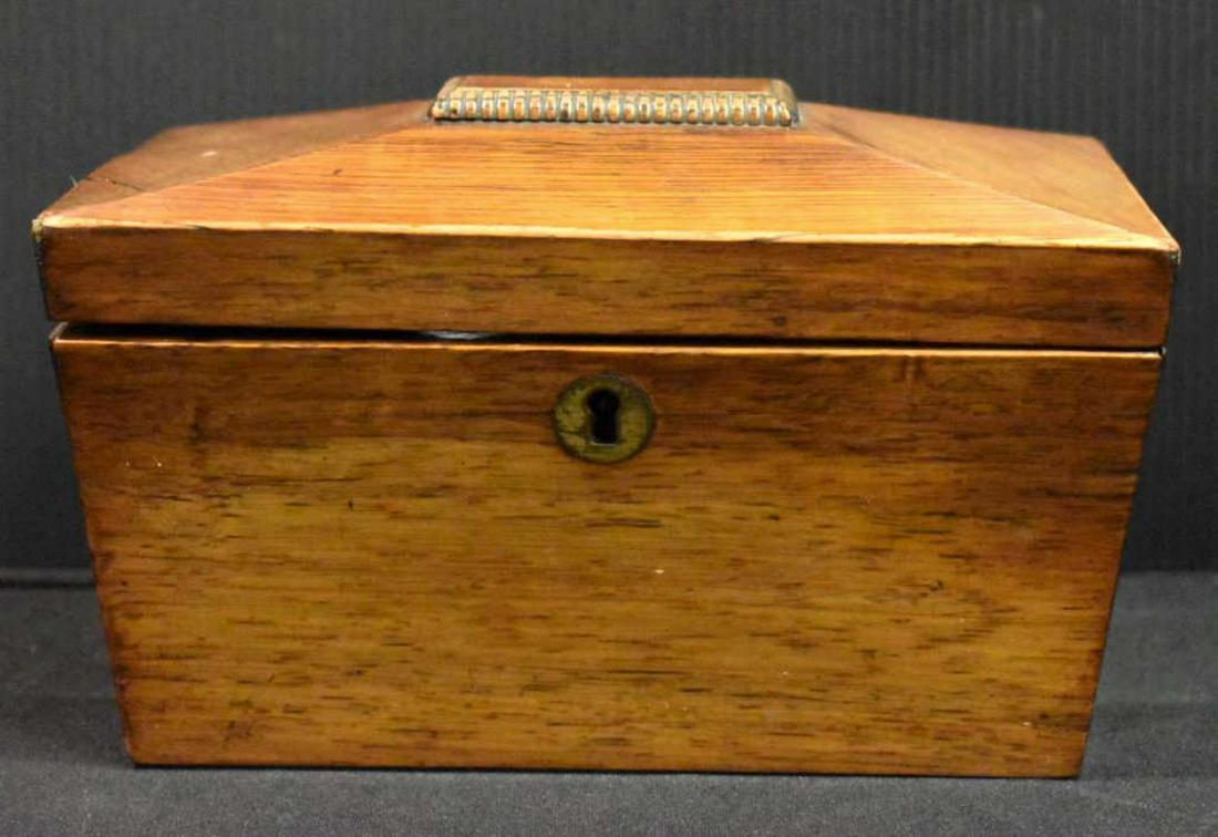 Tea Caddy: Tea Caddy. Sarcophagus form in Maple veneer with brass escutcheon and lock, interior lids lift with wooden finials, 5 1/4"h. 8"w. Veneer splits and it had ball feet at one time.