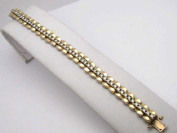14kyg straight line diamond bracelet 3ctw: Lady's 14kyg straight line diamond bracelet 37.3 grams with round full cut diamonds prong set 3ctw with VS2-SI2 clarity and H-J color. Comes with 14kyg bracelet jacket.