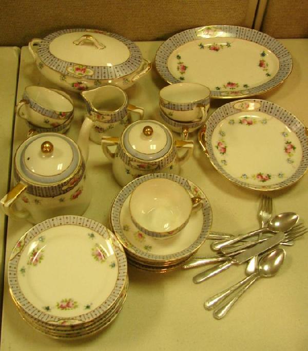 Noritake Morimura Child's Tea Set: Noritake Morimura child's tea set consisting of 6 plates, 5 cups, 6 saucers, cov'd teapot, handled cookie plate, oval plate, covered oval dish, covered sugar and creamer, 9 utensils. One cup has been 