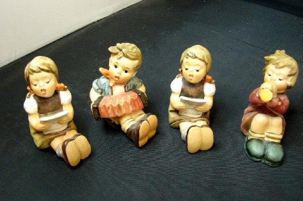 4 Hummels: Girls w/Sheet Music, boy w/accordion &m: 4 Hummels: 2 Girls with Sheet Music, boy with accordion and boy with trumpet; all tmk 5, no chips or cracks, approx. 3" tall.