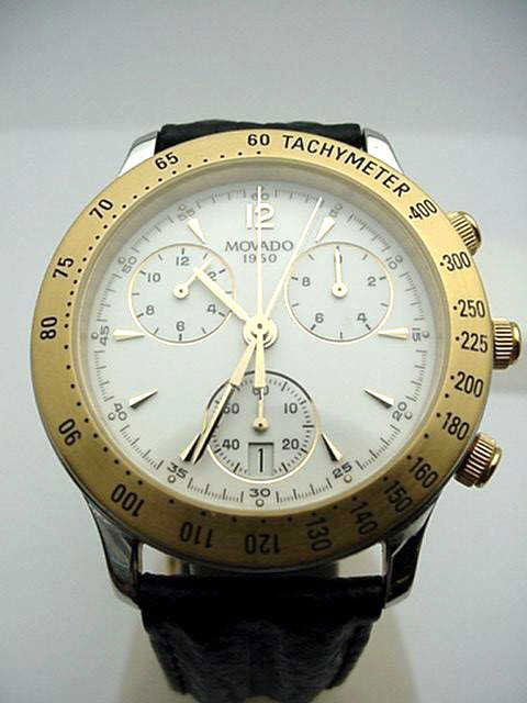 Stainless Movado Chronograph watch: Man's stainless Movado chronograph with gold bezel, quartz movement, water resistant, tachometer and leather band. Comes with box and papers.