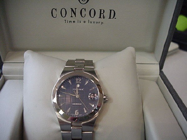 Man's Concord Mariner watch: Man's Concord Mariner stainless watch with blue linen dial with date, water resistant and comes with box and papers. Never been warn.