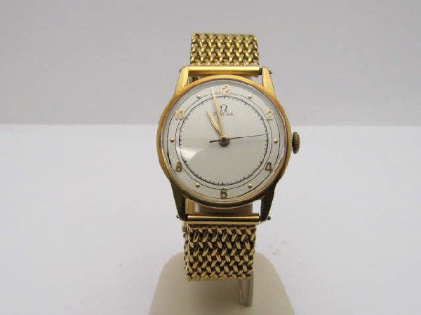 18kyg Omega dress watch: Man's vintage 18kyg Omega dress watch 72.3 grams with white dial and gold hands, 16 jewel mechanical movement, foxtail weave band and adjustable clasp.