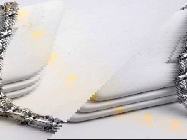 14k 2tone diamond baguette bracelet: Lady's 14k 2tone diamond bracelet 8 grams with tapered diamond baguettes channel set in white gold 1.50ctw with double "X" between links in yellow. 8 inches in length.