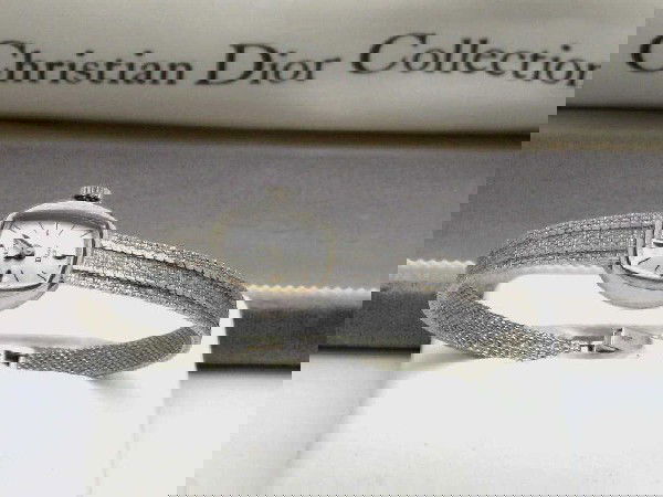 14kwg Bulova watch Dior Collection: Lady's 14kwg Bulova watch from the Christian Dior Collection with silver dial, 23 jewel movement and textured mesh band. Comes with original box.