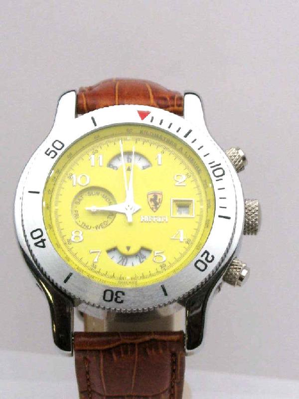 Stainless automatic Ferrari watch: Stainless Ferrari watch with automatic movement with window on back, yellow dial with day and date indicator, water resistant and tan leather band.