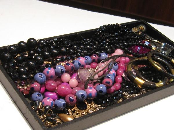 Lot of costume jewelry: Lot of costume jewelry in the magenta and pink theme with necklaces, earrings ,bracelets and pins and some black beads.