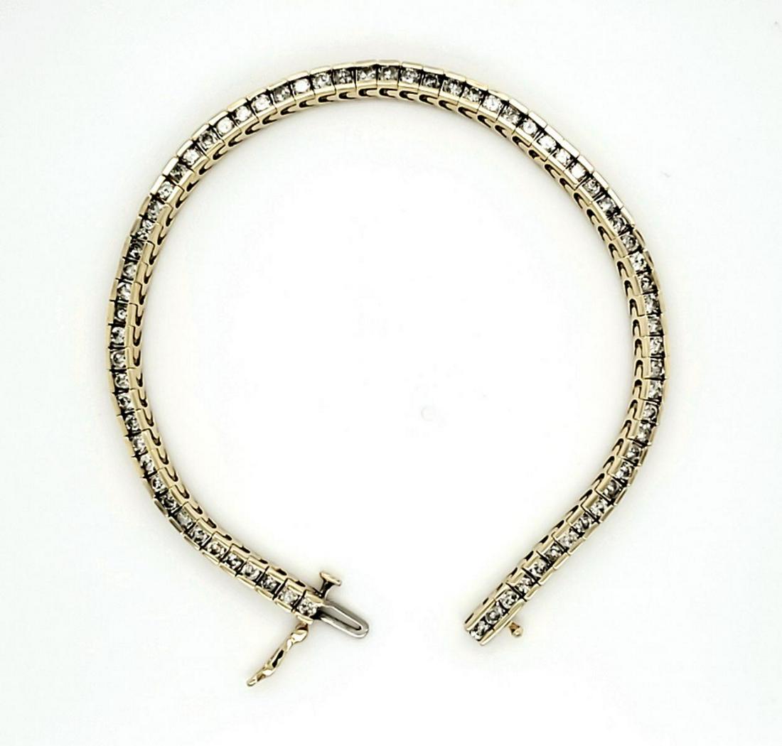14kt yellow gold diamond tennis bracelet: Ladies 14kt yellow gold diamond tennis bracelet featuring channel set round brilliant cut diamonds weighing approx. 2.85ct., Clarity I1-I2, Color I-J. Length 7.5". Weight 11.9 grams.