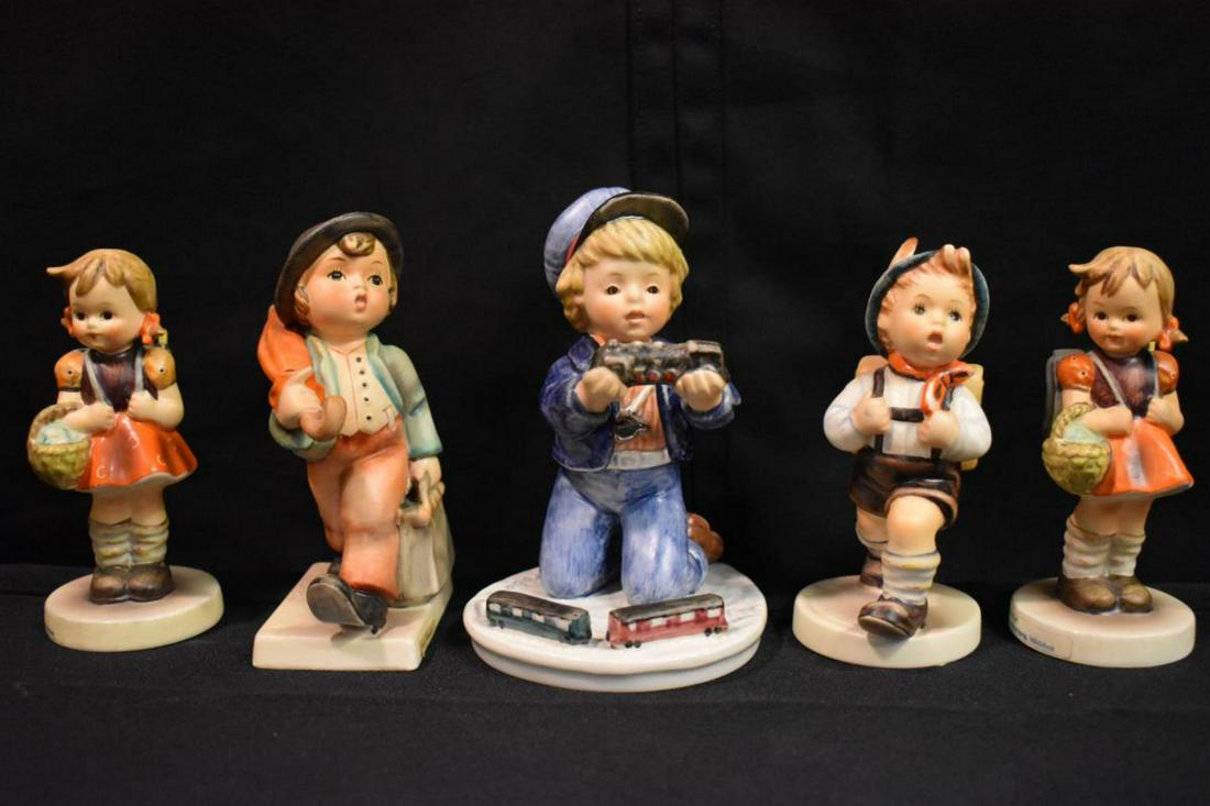 Group Of Hummel Figurines: Group Of Hummel Figurines. Total of 5 figurines in the group. Consists of School Girl. Boy With Trains. School Girl. School Boy. Merry Wanderer. Sizes range from 4 1/2"-5 1/2" tall.