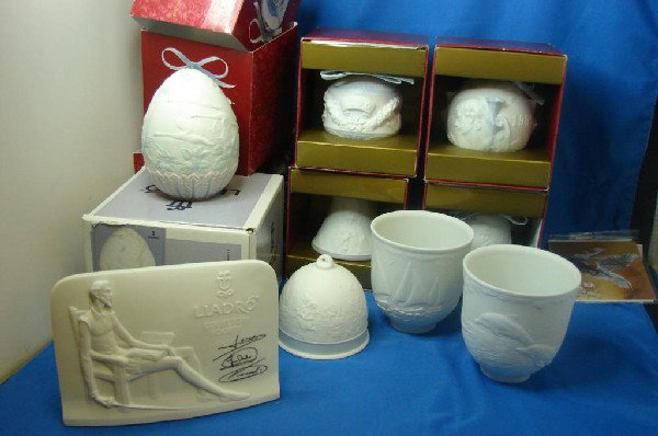 9 Lladro Christmas Bells & Ornaments: Lladro 1994 Ltd. Ed. Egg, 1999 & 2000 Christmas Balls, 1999 and 2000 Christmas Bells, 1994 Collector's Society Bell, 1997 and 1998 Sailboat & Dolphin Cups, and a Lladro Plaque. 5 items have orig. boxe