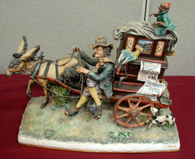 Hand sculptured in Italy Borsato-like Figurine: Figurine of an Organ Grinder with his monkey is marked Hand Sculptured Works of Art Italy 320 on bottom; it looks like Borsato but it is not signed.16" l x 7" x 14"h. One of the wheels has been glued