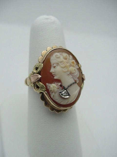 Tri color cameo ring with diamond: Lady's tri color cameo ring 6.2 grams with 15X10mm cameo diamond bezel set in a tri colored ribbon design in 10k gold with finger size 7 1/2.