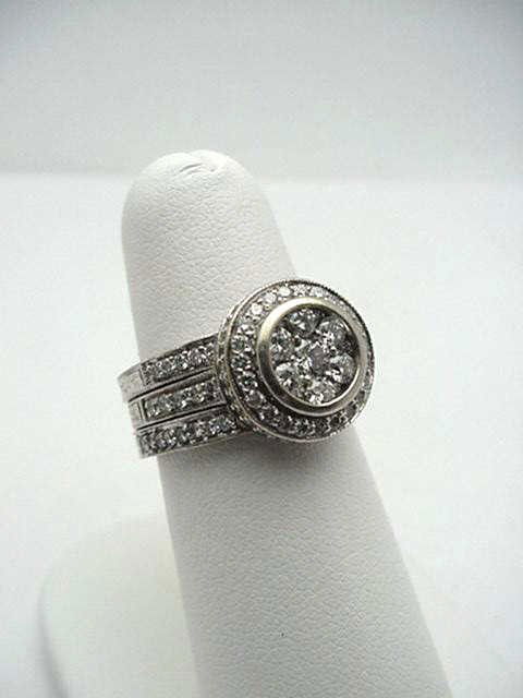 Trio set 18kwg diamond bridal 2ctw: Lady's 18kwg 3ring diamond bridal set 11 grams with 14 round full cut diamonds in a circle surrounded by prong set diamonds top and side along with 2 matching engraved diamond bands 2ctw. Finger size
