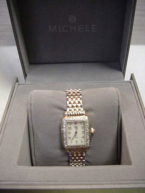 Lady's Michelle diamond watch: Lady's rose gold and stainless Michelle watch with square mop dial, diamond bezel with .36ctw diamonds, sapphire crystal, Swiss movement and water resistant with box and papers. Like New!