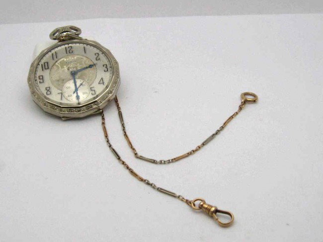 Elgin pocket watch with 14k fob: Elgin Tivoli open faced pocket watch 14k gold plated with silver filigree face and second hand inset, fancy filigree bezel and filigree engraved back. Comes with 15"2tone watch fob 4.4 grams. Good wor