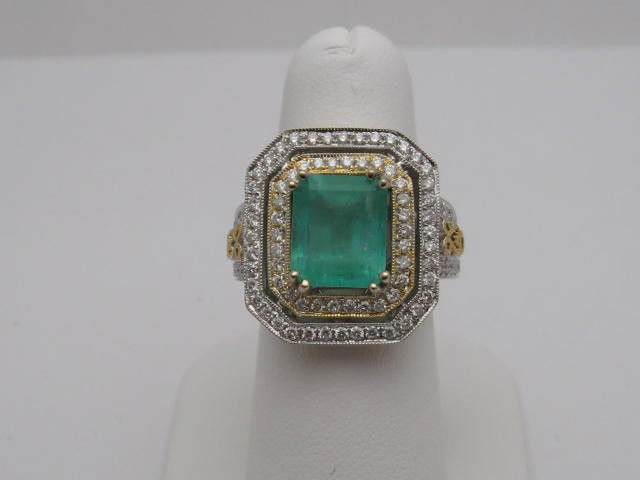 Lady's emerald & diamond ring; 3.92 ct emerald: Lady's 14k 2tone emerald and diamond ring 13.9 grams with emerald cut emerald weighing 3.92ct prong set with type2 clarity and transparent bluish green color. Surrounding center are 2 rows of round di