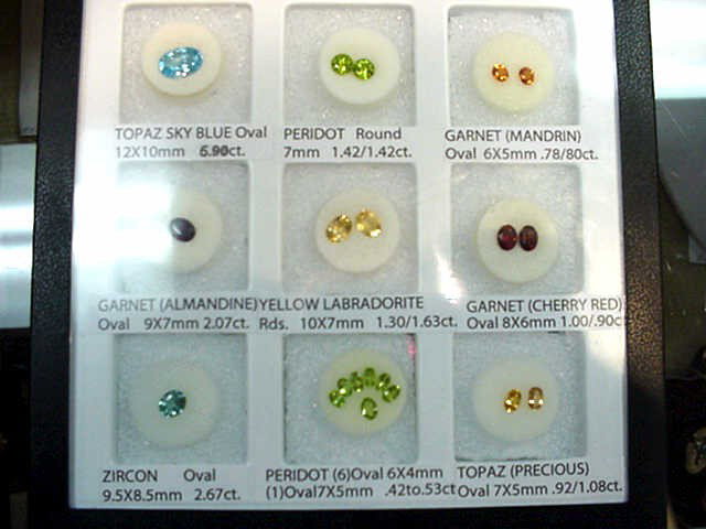 Ass't semi precious stone in display: Set of semi precious stones including topaz, peridot, garnet, zircon and more in nice display box.