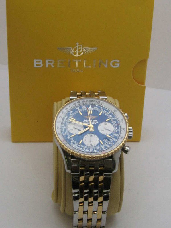 Breitling Navitimer Chronograph watch: Man's Breitling Navitimer Chronometer sport watch in 18ky and stainless with black dial, sapphire crystal, 18ky bezel, automatic movement, and chronograph hours, minutes and seconds. Comes with box an