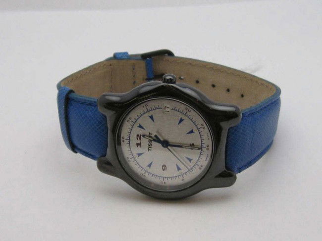 Ceramic new Tissot watch blue: New Tissot watch with ceramic case, silver and blue dial, calendar, Swiss movement and blue leather band.
