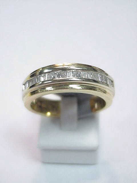Man's 14kyg diamond wedding ring: Man's 14kyg diamond band 10 grams with channel set diamond baguettes 1ctw. Finger size 101/2.