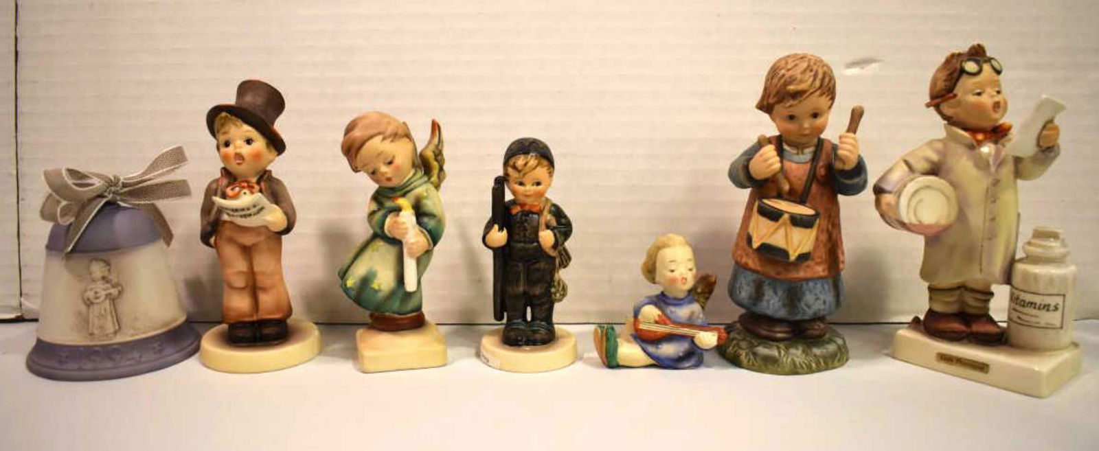Group Of Hummels: Group Of Hummels. Total of 6 Hummels in the group. Consists Chimney Sweep. Heavenly Angel. Joyous News Angel With Lute. Little Pharmacist. Street. Drummer Boy. Sizes range from 2"-6" high. There are n