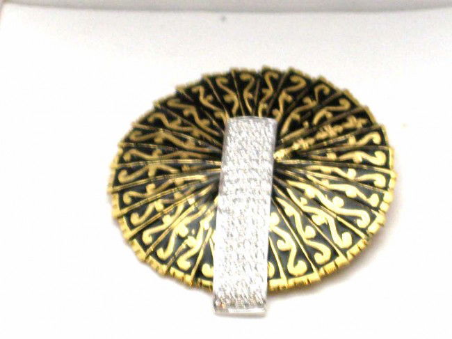 18kyg inlay diamond pendant .47ctw: Lady's 18kyg diamond pendant 11.6 grams with circular design 13/8'" diameter with black inlay and one inch bar of pave diamonds .47ctw with 20" link chain. Can be used as pin.