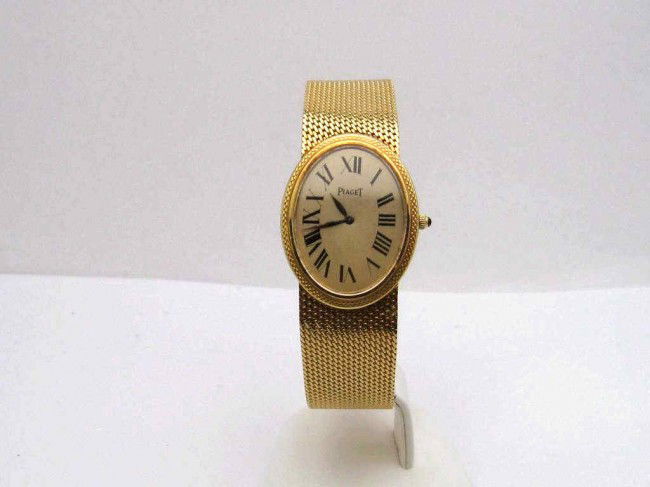 18kyg Piaget watch oval face 56gr: 18kyg Piaget watch 56gr gold oval dial black roman numbers, sapphire crown and tapered mesh band.