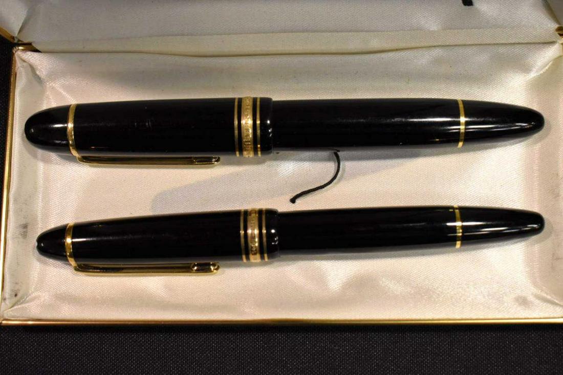 Pair of Mont Blanc Meisterstruck Fountain Pens 14k: Montblanc Meisterstruck #146 Fountain Pen In Case With Paperwork Made in Germany. 14K medium nib. Excellent condition. Black with gold tone trim & white end. Also included is a Montblanc Meisterstruck