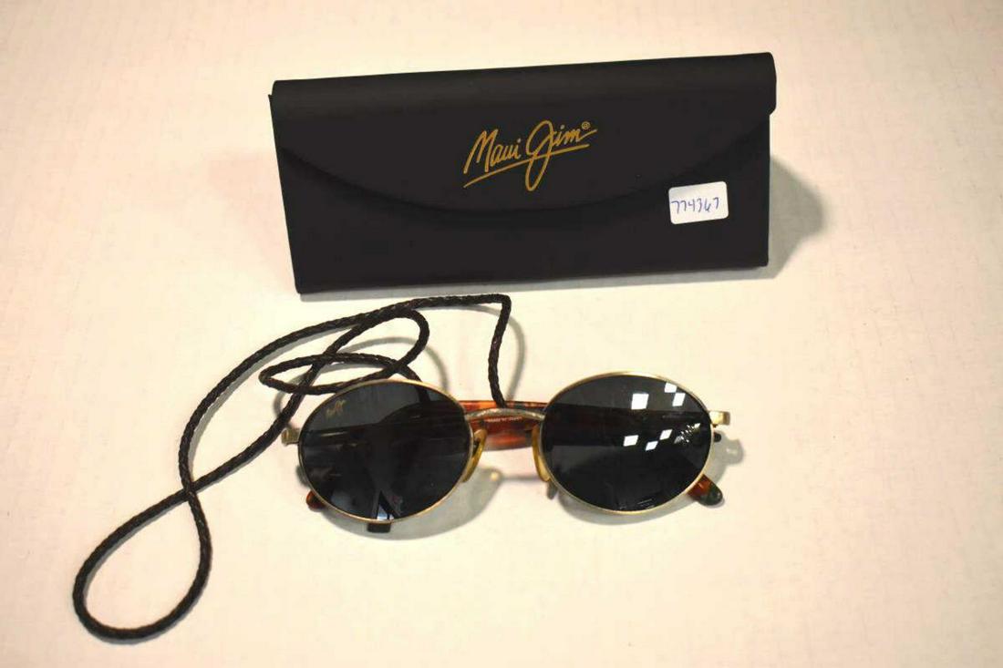 Pair Of Maui Jim Sunglasses: Pair Of Maui Jim Sunglasses. Comes with case. Maui Jim located on the upper right hand corner of the lenses. Glasses are in great condition. Case is also in great condition.