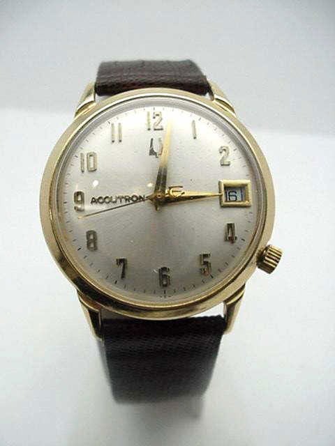 Vintage 14kyg Bulova Accutron watch: Vintage 14kyg Bulova Accutron with silver dial gold numbers,date window,mechanical movement, brown leather band and like new condition