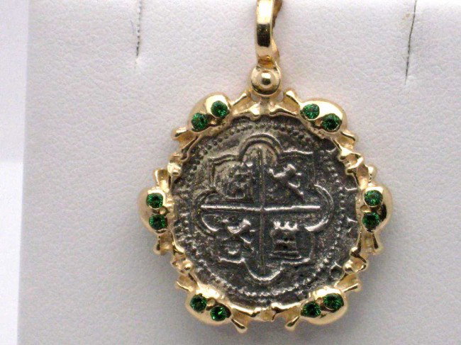Shipwreck coin 14kyg bezel tsavorite: Shipwreck coin pendant 5gr with 12 round tsavorite garnets mounted in the freeform frame 1inch diameter 18" cable chain.