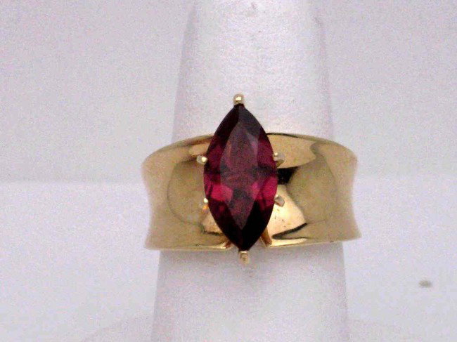 14kyg rhodelite garnet ring: 14kyg garnet ring 9.3gr with marquise shaped rhodelite garnet weighing approx. 3ct prong set 11mm tapered band finger size 7.