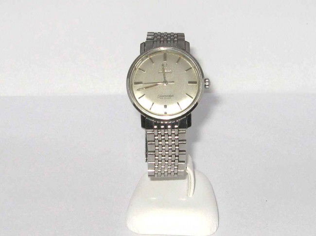 Man's Omega Seamaster Deville: Man's stainless Omega Seamaster Deville silver stick dial, automatic movement, water resistant and original band.